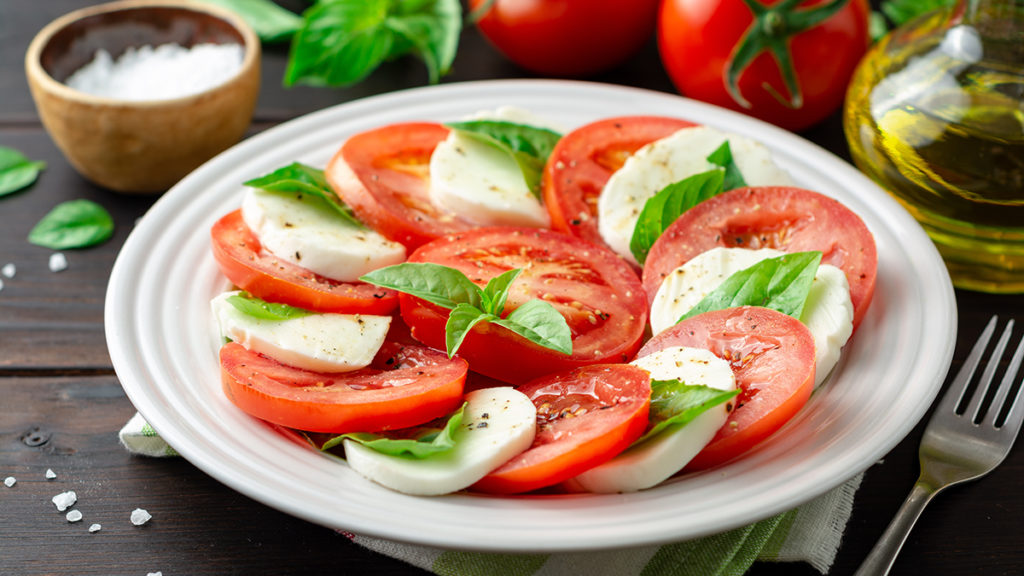 Photo of salads with a caprese salad on a plate