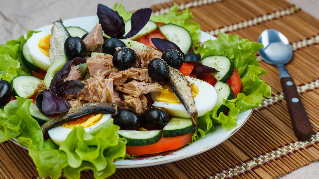 Photo of salads with a nicose salad on a plate