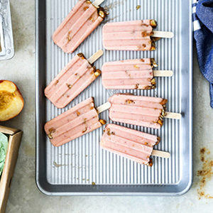 Photo of summer desserts with several fruit popsicles on a silver tray.