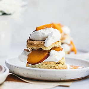 Photo of summer desserts with a peaches and cream shortcake on a plate.