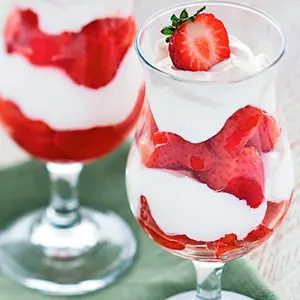 Photo of summer desserts with two strawberry parfaits