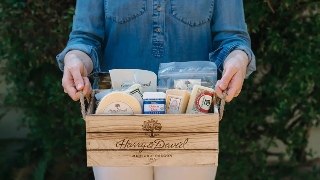 A photo of teacher gifts with someone holding a box of cheese