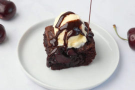 Cherry chocolate brownie with vanilla icecream and chocolate syrup on top