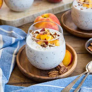 August recipes with a bowl of peaches and cream overnight oats