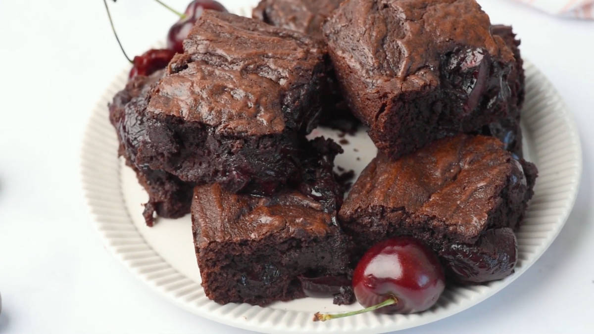 Cherry brownies on a plate with cherries
