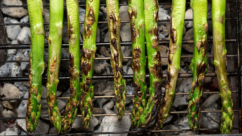 Photo of how to grill with a closeup of grilled asparagus