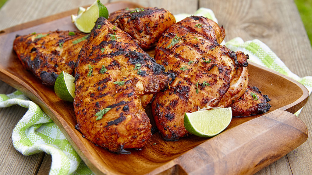 Photo of how to grill with a plate of grilled chicken breast.