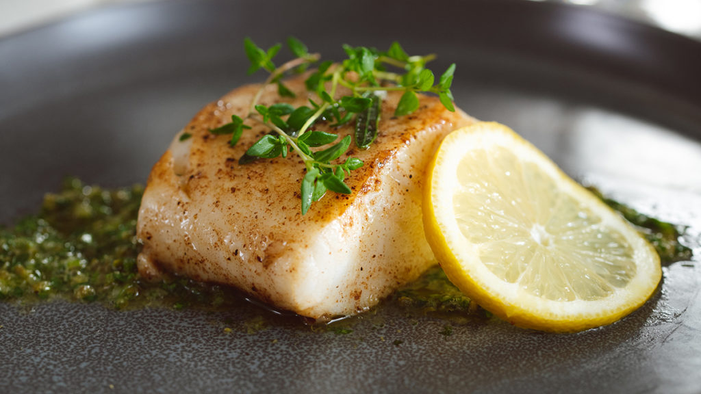 Sea bass with thyme and lemon on a bed of caper and mint relish.