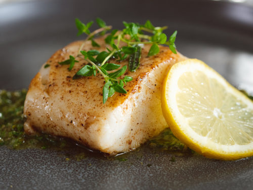Sea bass with thyme and lemon on a bed of caper and mint relish.