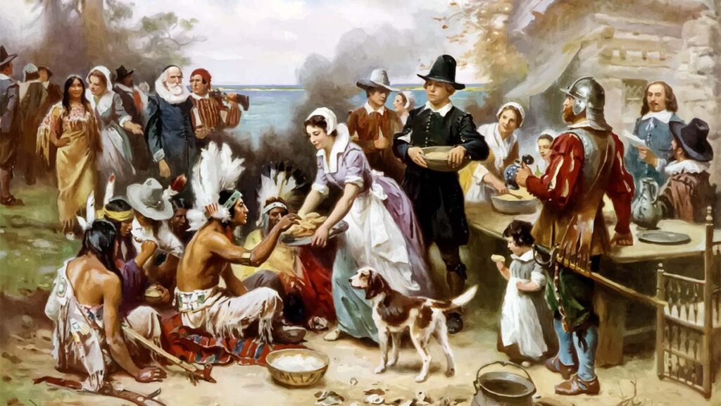 When is thanksgiving with a painting of pilgrims and Native Americans.
