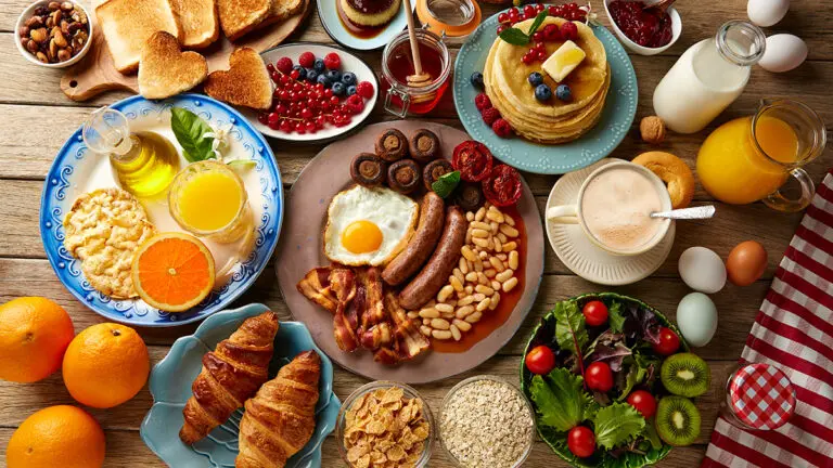 Breakfast meat and other breakfast items on a table.