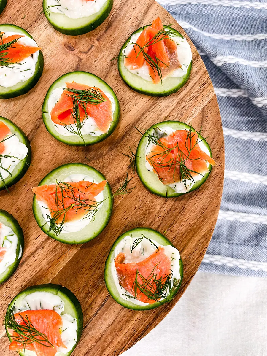 Easy dinner ideas with a wooden board full of cucumber salmon bites.