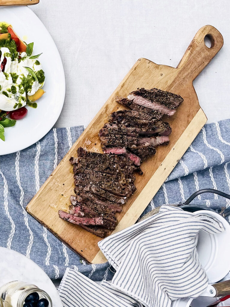Easy dinner ideas with a sliced steak on a board.
