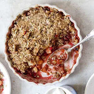 September recipes with a pie dish full of apple cranberry crisp.