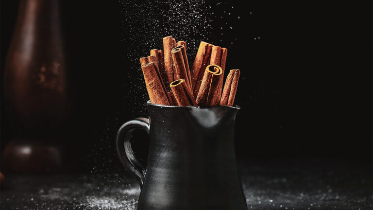 Cinnamon sticks on a black mug