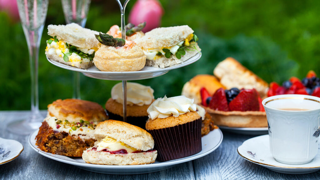Birthday party food ideas with a high tea tray on a table.