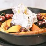 Peach and Roasted Cherry Dutch Baby Pancake With Marionberry Whipped Cream