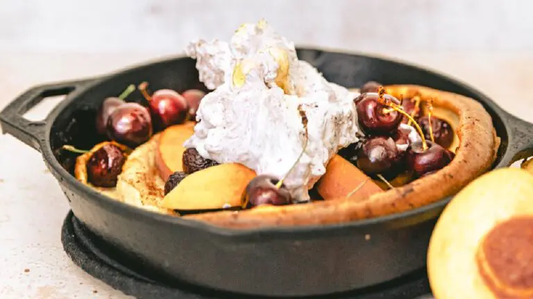 A closeup of a dutch baby pancake in a frying pan