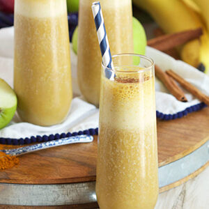 Fall recipes with an apple tumeric smoothie on a board.
