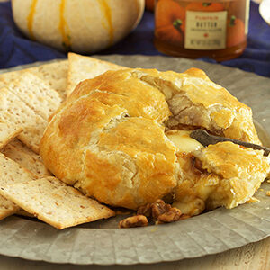 Fall recipes with a baked brie and crackers on a plate.