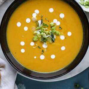 Fall recipes with a closeup of a bowl of pear butternut squash soup