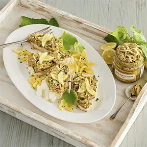 Fall recipes with a plate of spaghetti next to a jar of artichoke lemon pesto