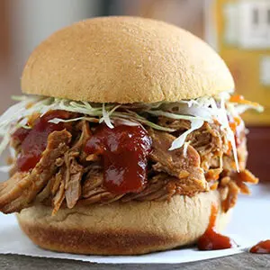 Fall recipes with a pulled pork sandwich on a plate.