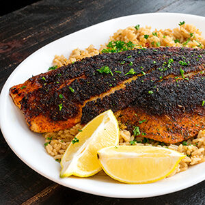 October recipes with a plate of blackened fish on a bed of grain.