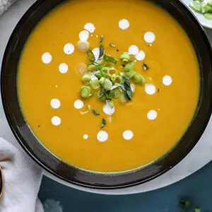October recipes with a closeup of a bowl of butternut squash and pear soup.