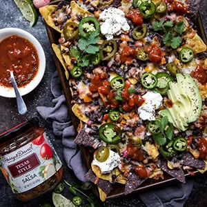 October recipes with a plate of nachos next to a bowl of salsa.