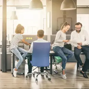 Office superstars sitting at a conference table.