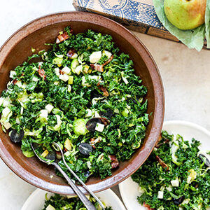 Pear recipes with a bowl of kale salad with pears and bacon.