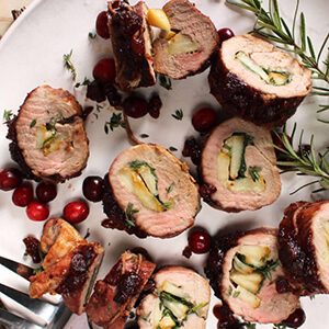 Pork recipes with a plate full of pork tenderloin stuffed with pears.