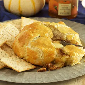 Pumpkin recipes with a plate of brie en croute and pumpkin butter.