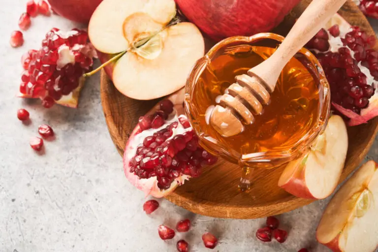 Rosh Hashanah sliced apples, pomegranate seeds and honey