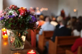 A vase of brightly colored flowers in a church