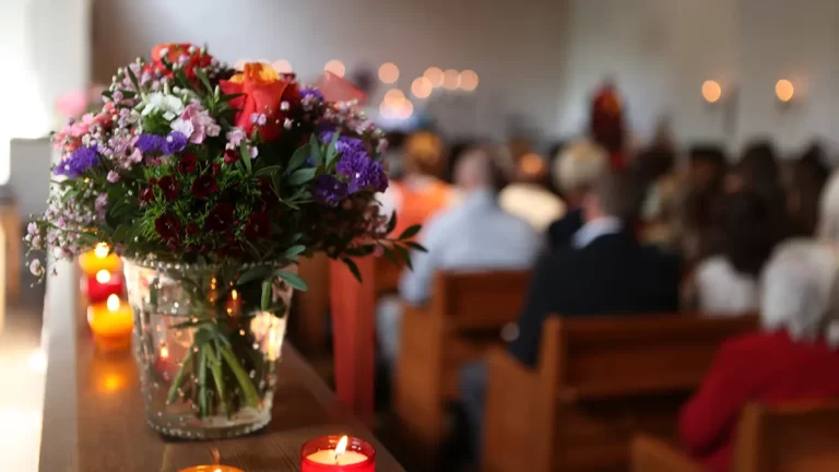 A vase of brightly colored flowers in a church