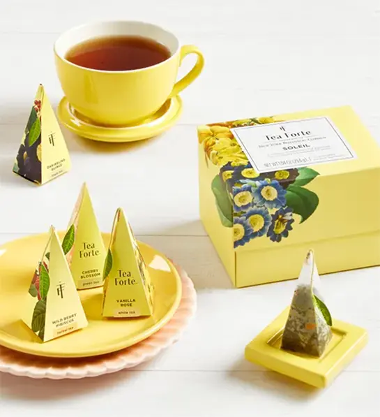 Boss's day gift ideas with a box of tea next to a cup of tea.