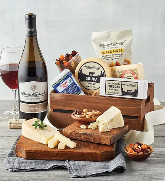 Boss's gift ideas with a box of cheese, wine and crackers.
