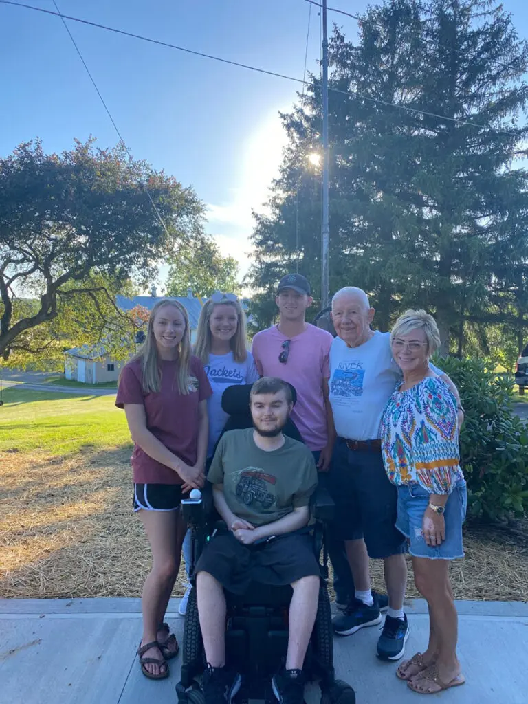 Caregiver family posing for a photo outside.