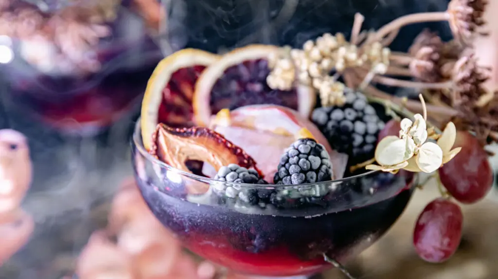 Halloween cocktail with fresh and dried fruit.