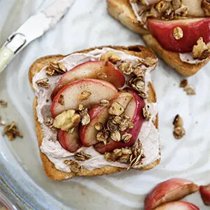 Thanksgiving recipes with a piece of toast with apples, granola and yogurt on it.