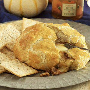 Thanksgiving recipes with a plate of baked brie and crackers.