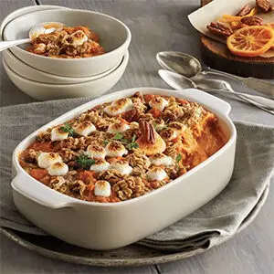 Thanksgiving recipes with a casserole dish of candied yams.
