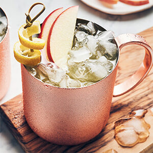 Thanksgiving recipes with a closeup of a Moscow mule with apple slices.