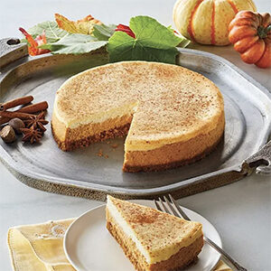 Thanksgiving recipes with a pumpkin cheesecake on a plate.