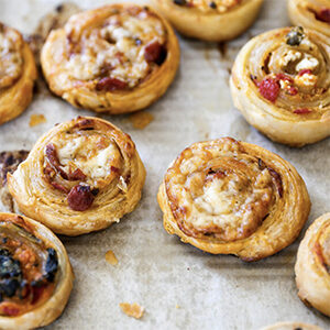 Thanksgiving recipes with a tray of savory puff pastry pinwheels.