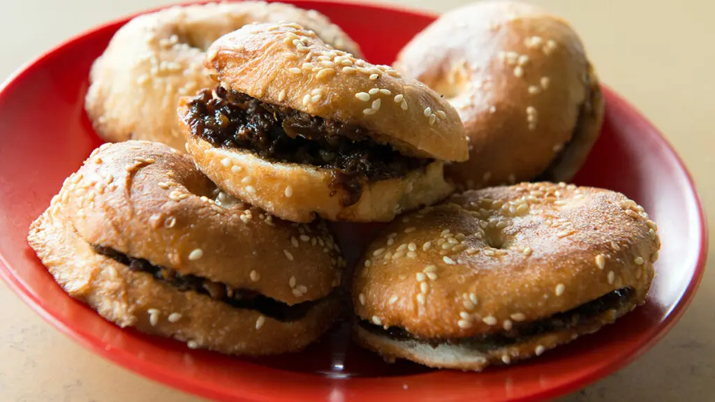 Types of bagels around the world with Chinese kompyang bagels on a plate.