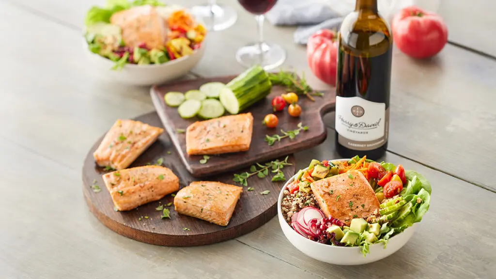 Wine infographic with a bottle of wine next to a plate of salmon and a bowl of salmon, grains and veggies.