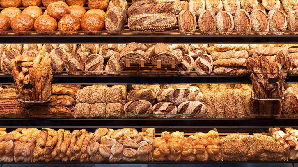 Types of bread on shelves in a store.